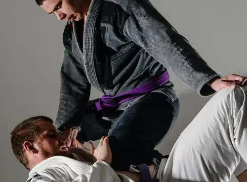 Adult Brazilian Jiu-Jitsu guard pass in dramatic studio light at Sentry Jiu-Jitsu